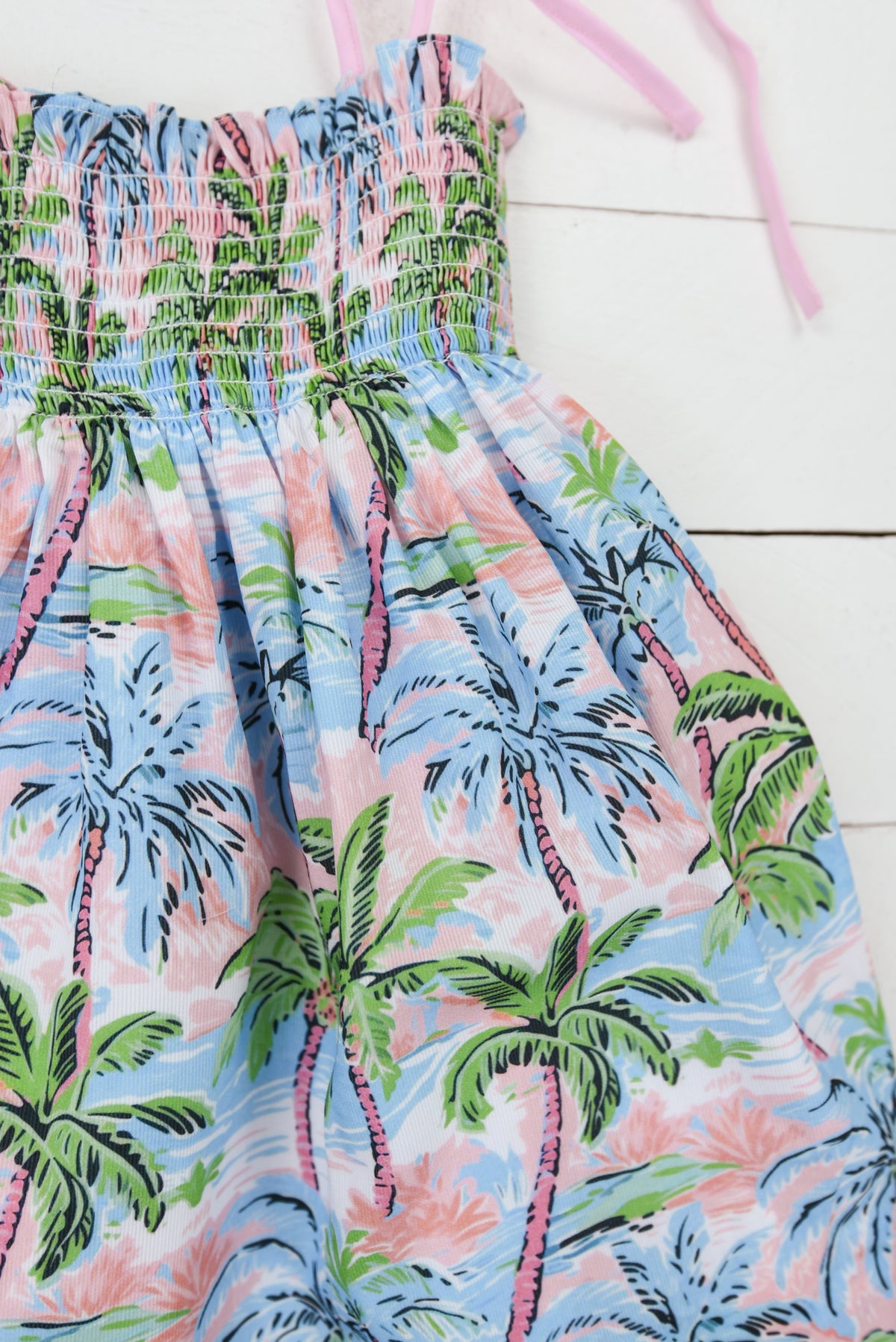 a pink and blue dress with palm trees on it