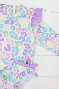a baby girl's swimsuit with a purple bow