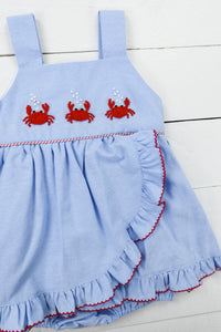 a blue dress with crab appliques on it