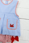 a blue dress with a crab applique on it