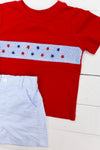 a red shirt and blue shorts on a white floor