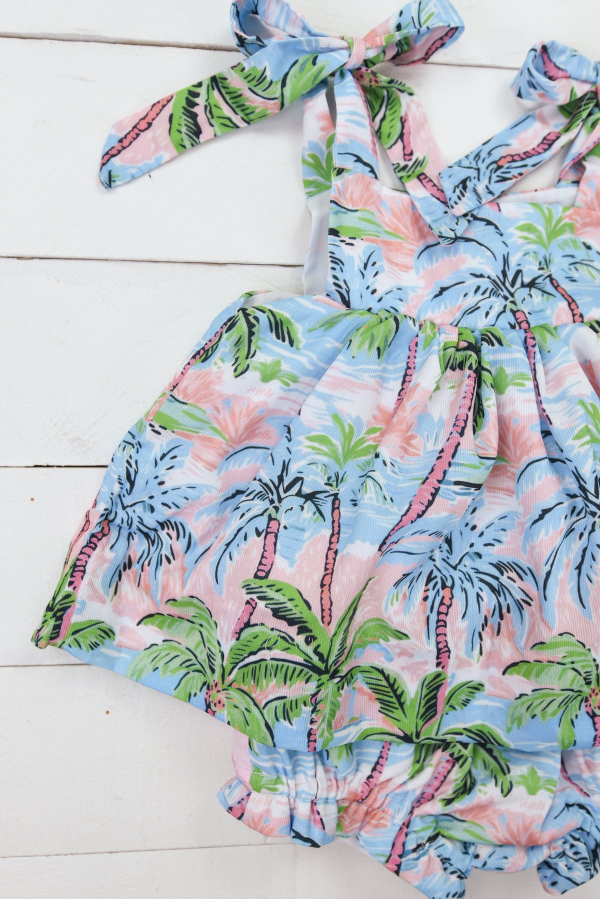 a blue and pink dress with palm trees on it