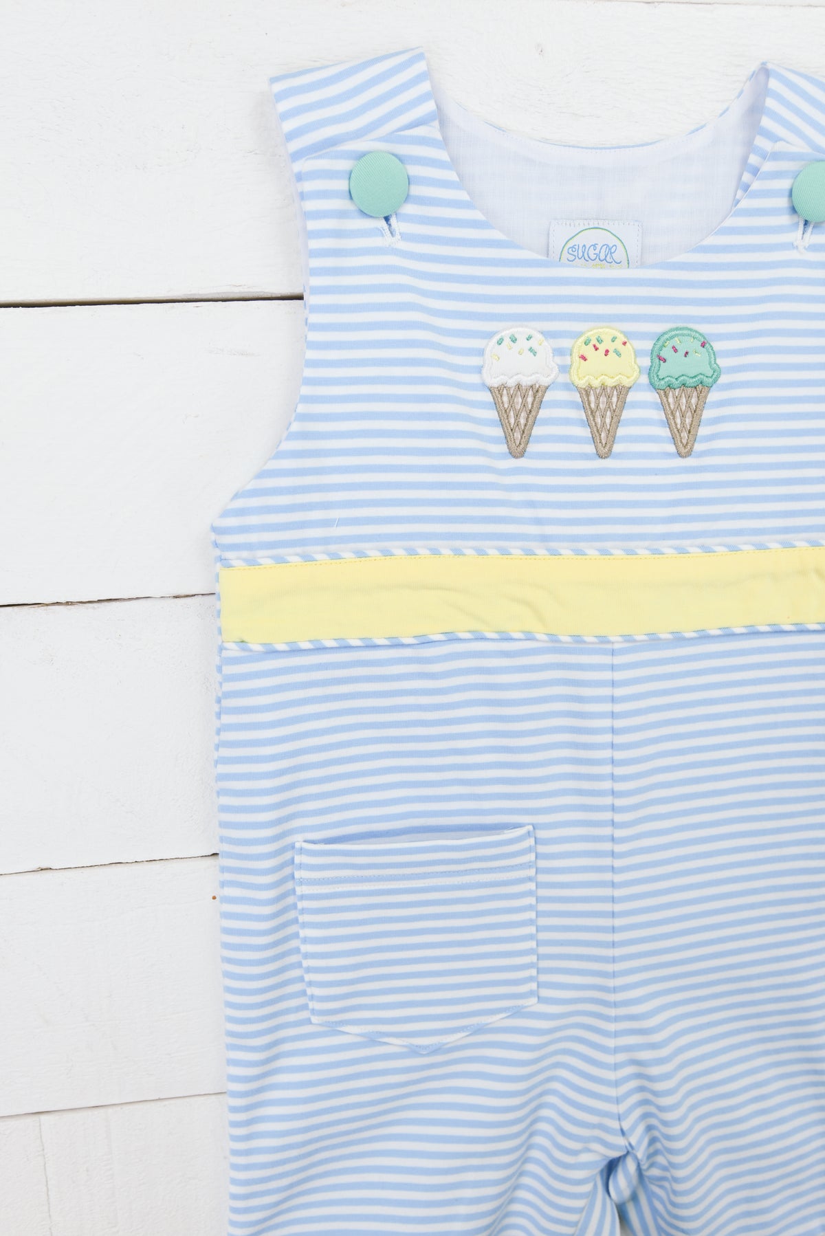a blue and white striped romper with cupcakes on it