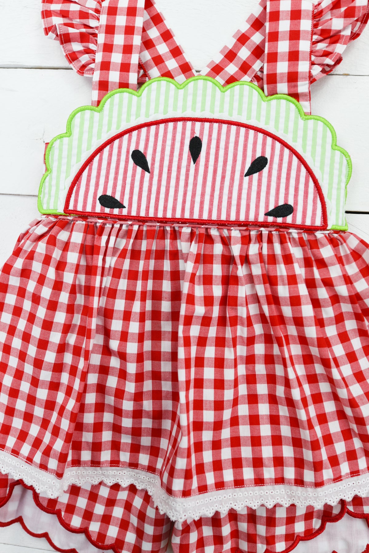 a red and white checkered dress with a green headband