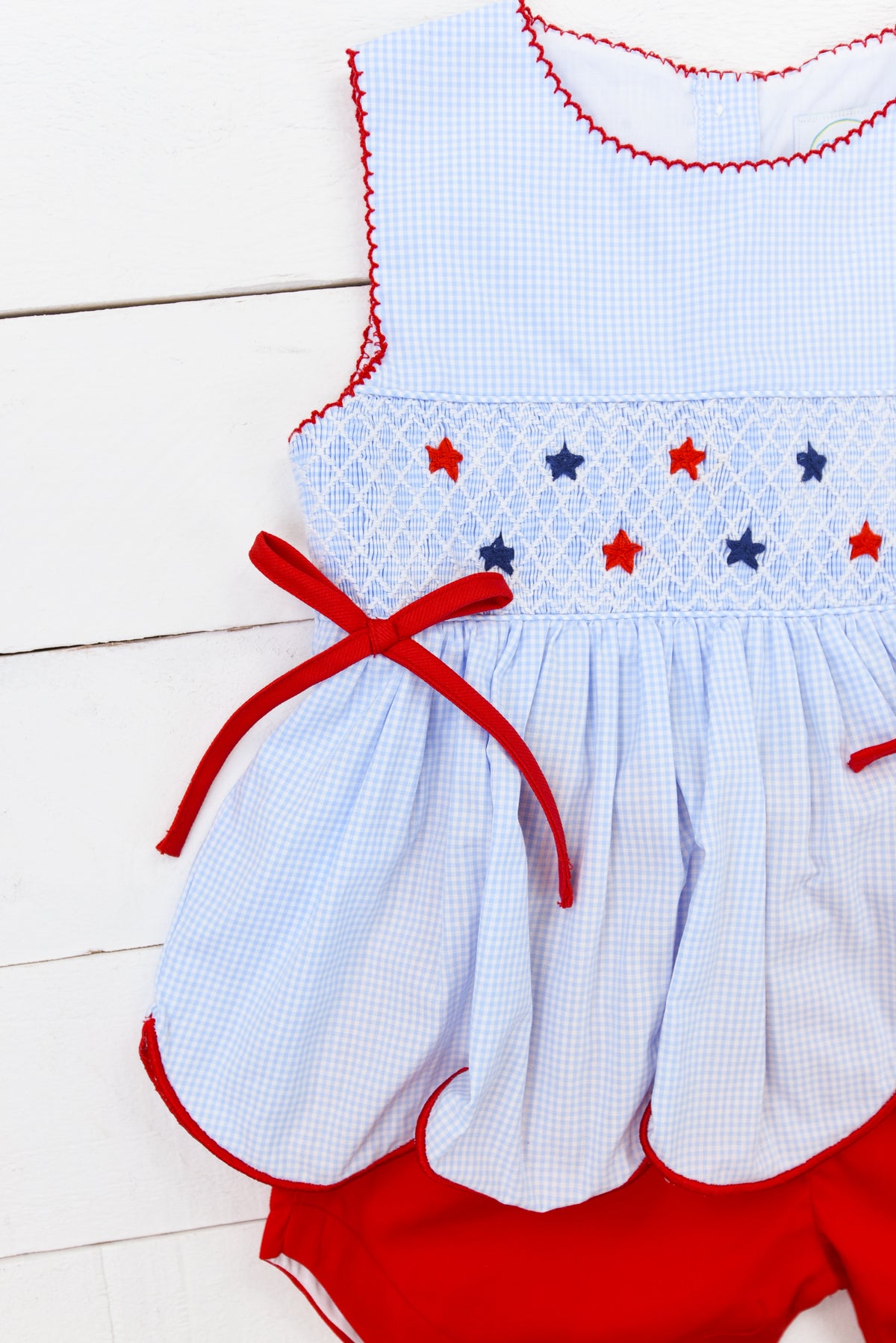 a baby girl's red and white dress and diaper cover