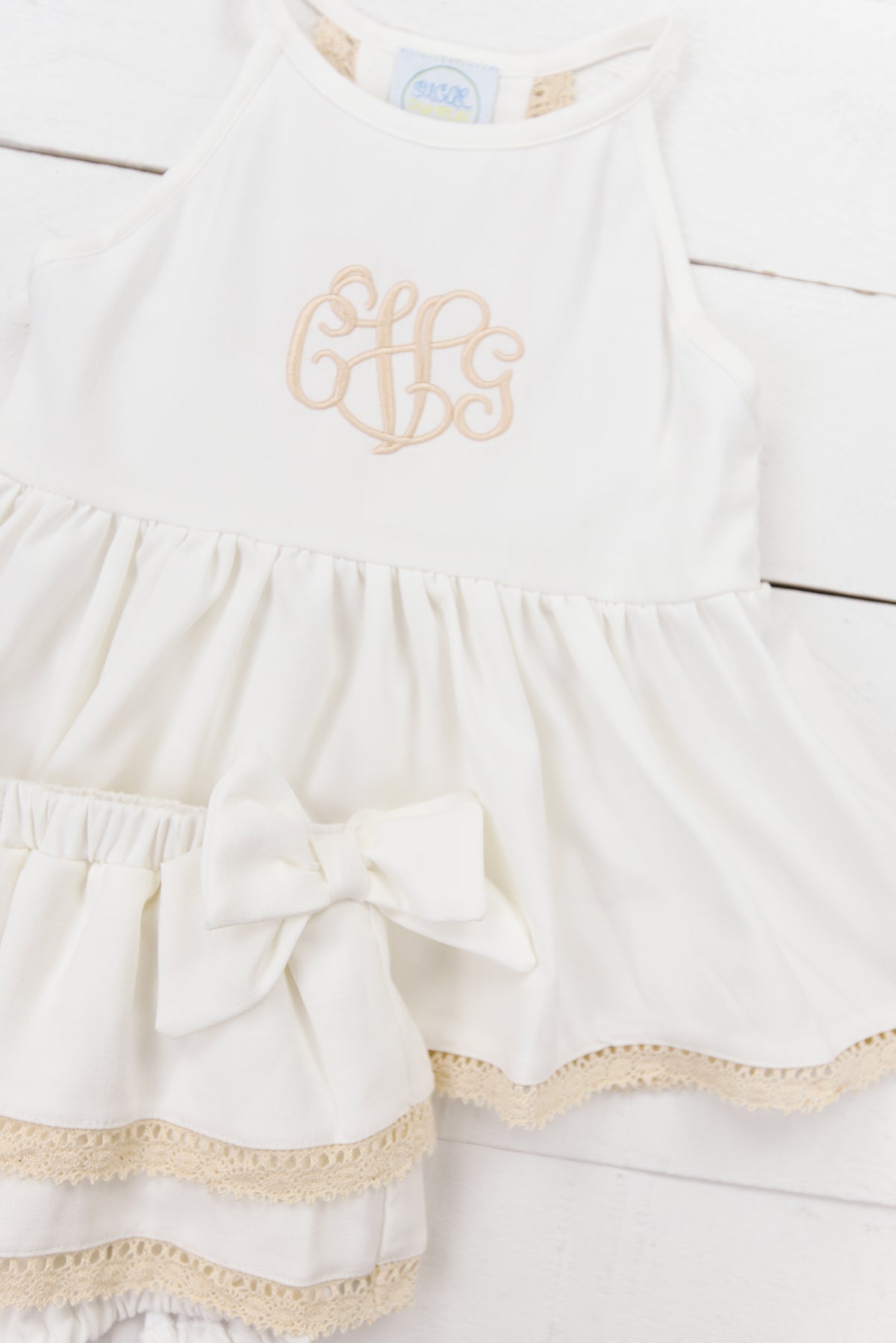 a white dress with a monogrammed mono on it