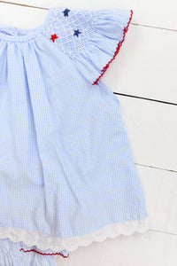 a blue and white dress with red stars on it