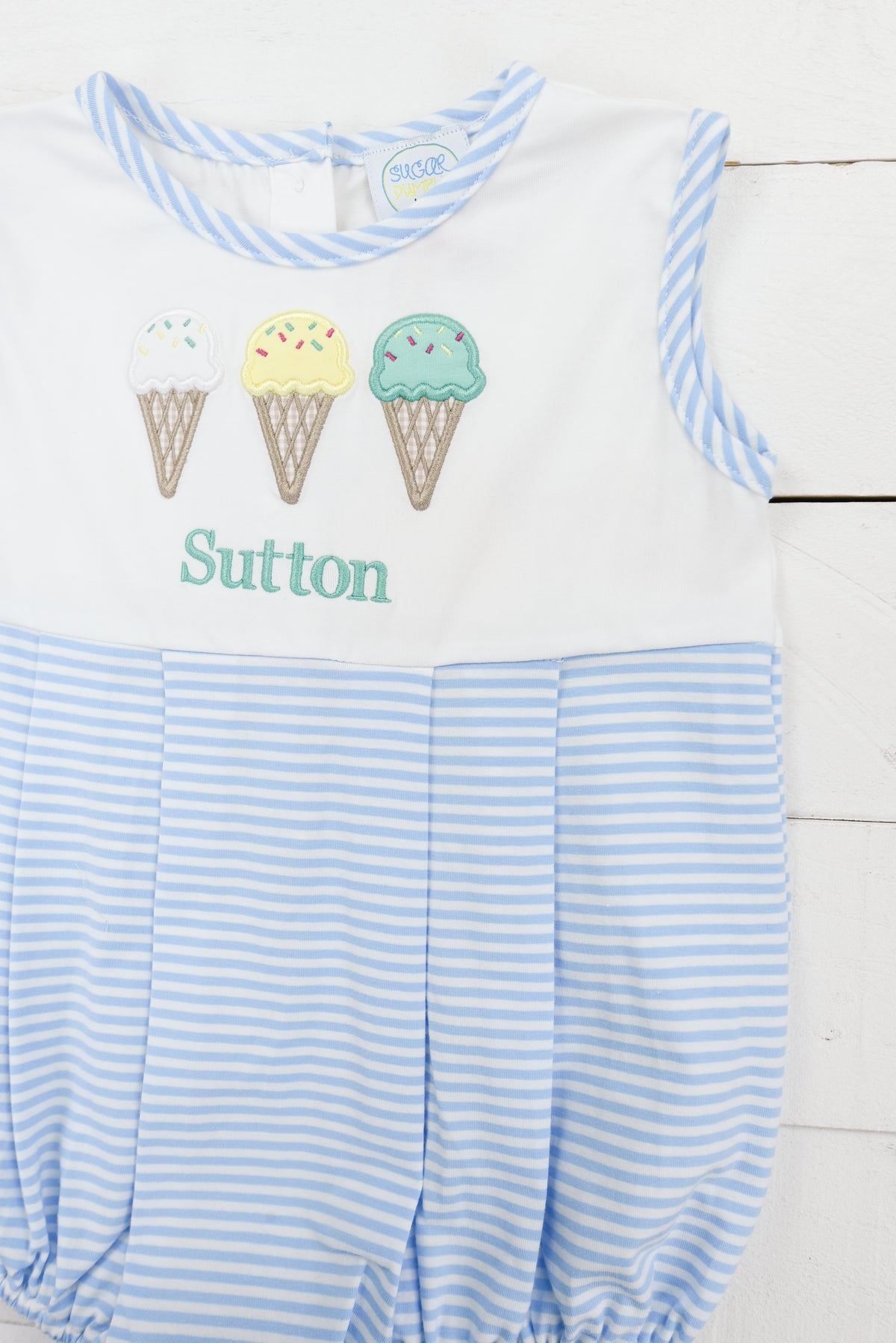 a blue and white striped romper with two ice cream cones on it