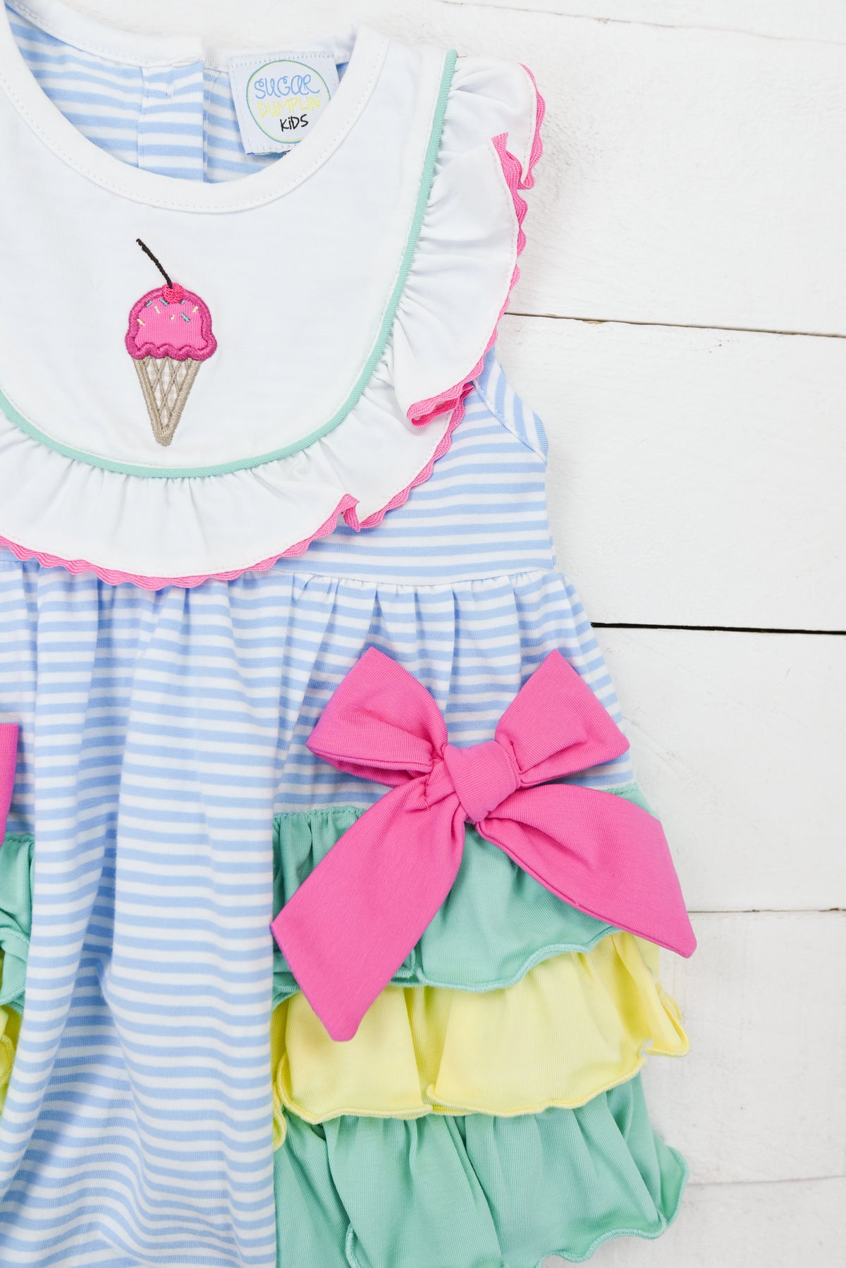 a blue and white striped dress with a pink ice cream cone on it