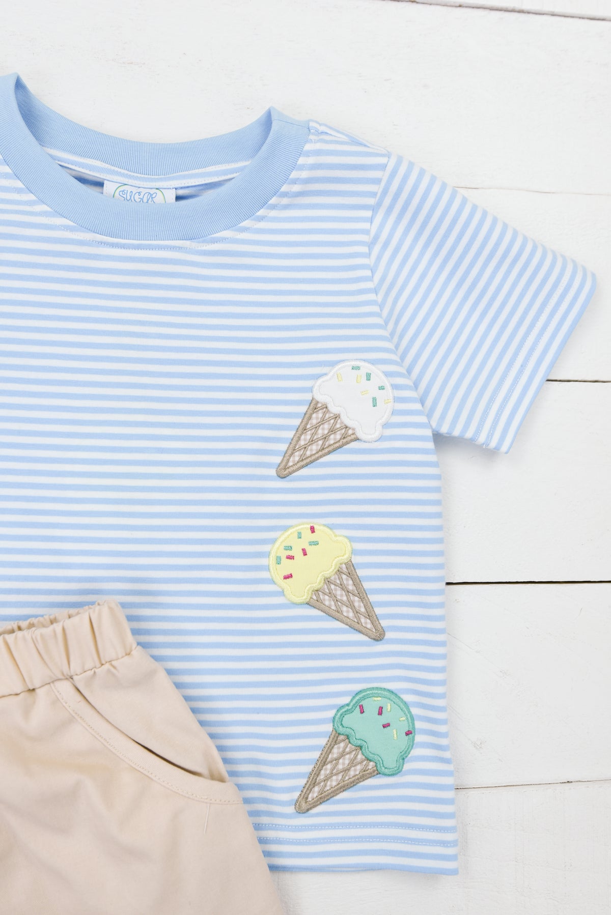 a blue and white striped shirt with ice cream on it