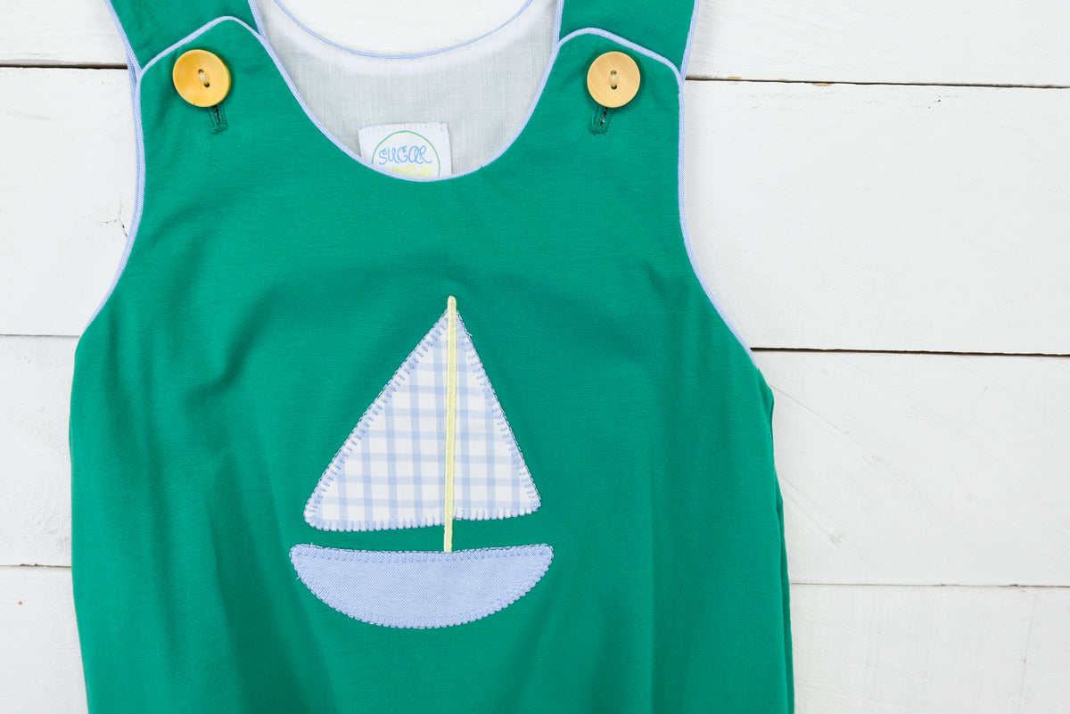 a green shirt with a sailboat on it